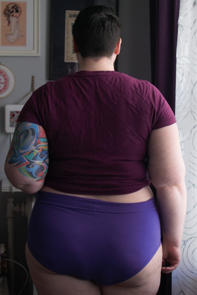 Back view of model wearing Classics brief in purple. Soft cotton fabric.