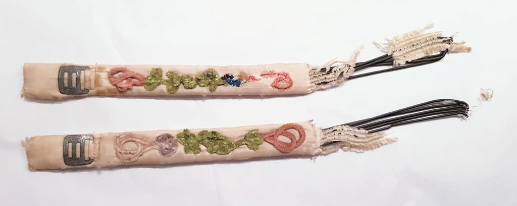 Embroidered and padded silk garters from the late 18th century. Due to the damage of poor storage and age, where the silk has disintegrated you can see the metal coils that would have originally given the garters some stretch. From the personal collection of Karolina Laskowska. 