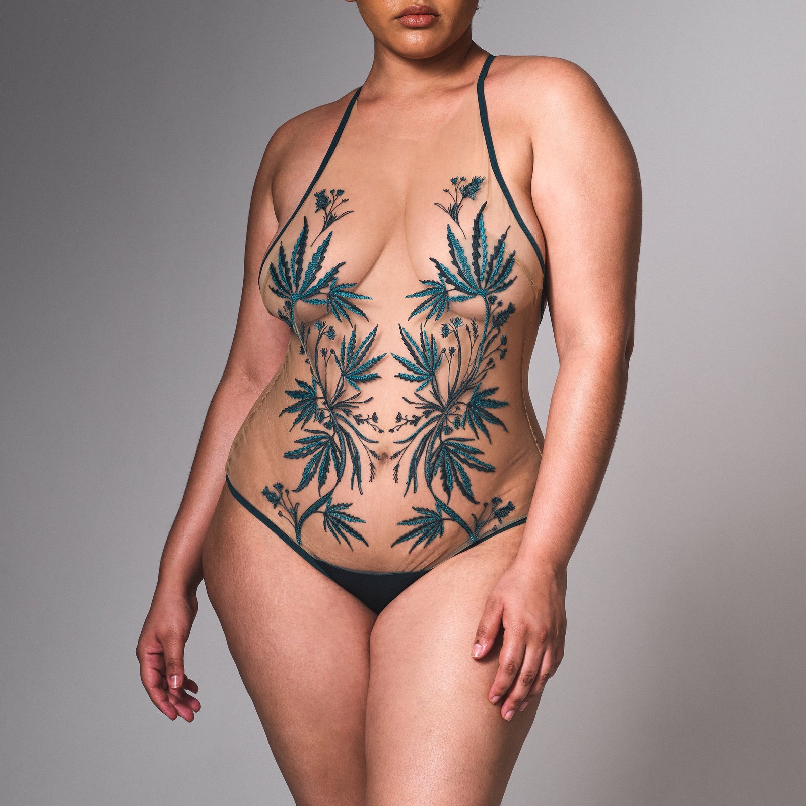 Thistle & Spire's "Brooklyn Haze" bodysuit features a fashionable take on cannabis with lush teal embroidery