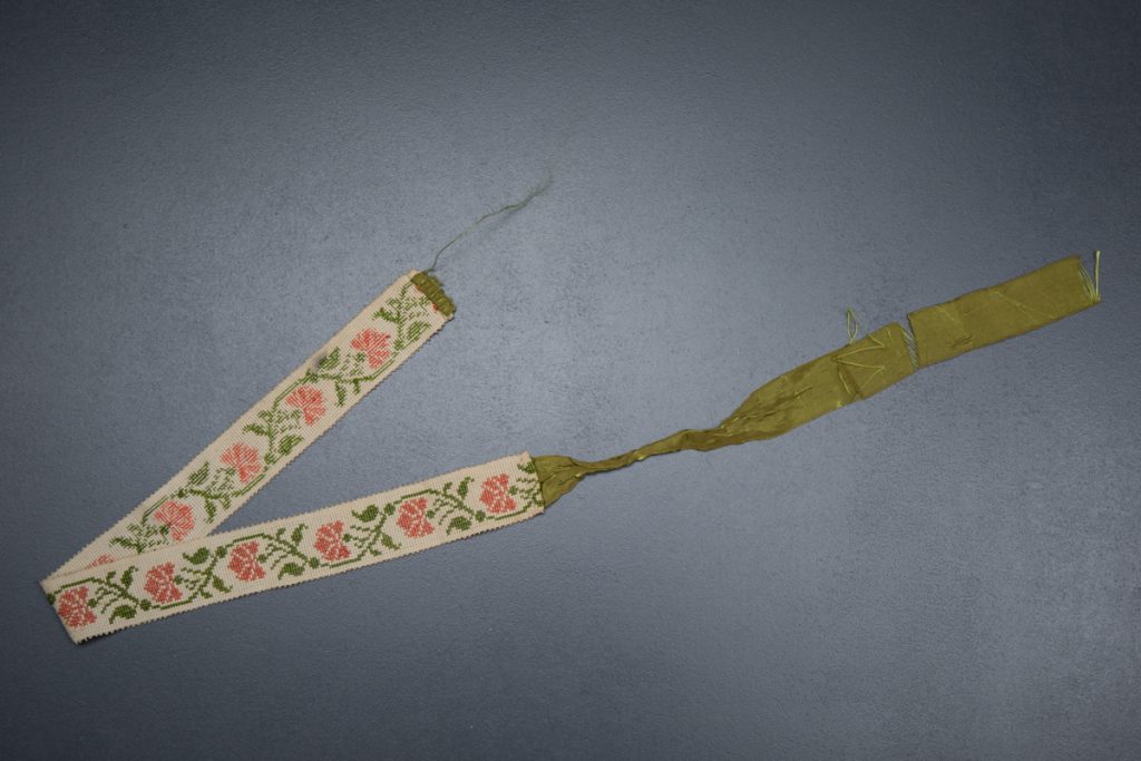 Cross stitched garter c. 1820s, Great Britain. From The Underpinnings Museum collection. Photography by Tigz Rice