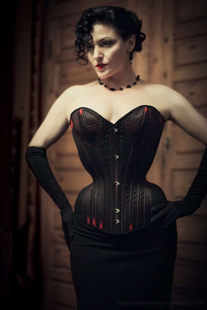 Dark Garden "Pearl" corset, modeled by proprietress Autumn Adamme. This bespoke piece was created by Autumn under the tutelage of corsetry legend Mr. Pearl, and features a short pipe-stem waist. | Photo © Joel Aron