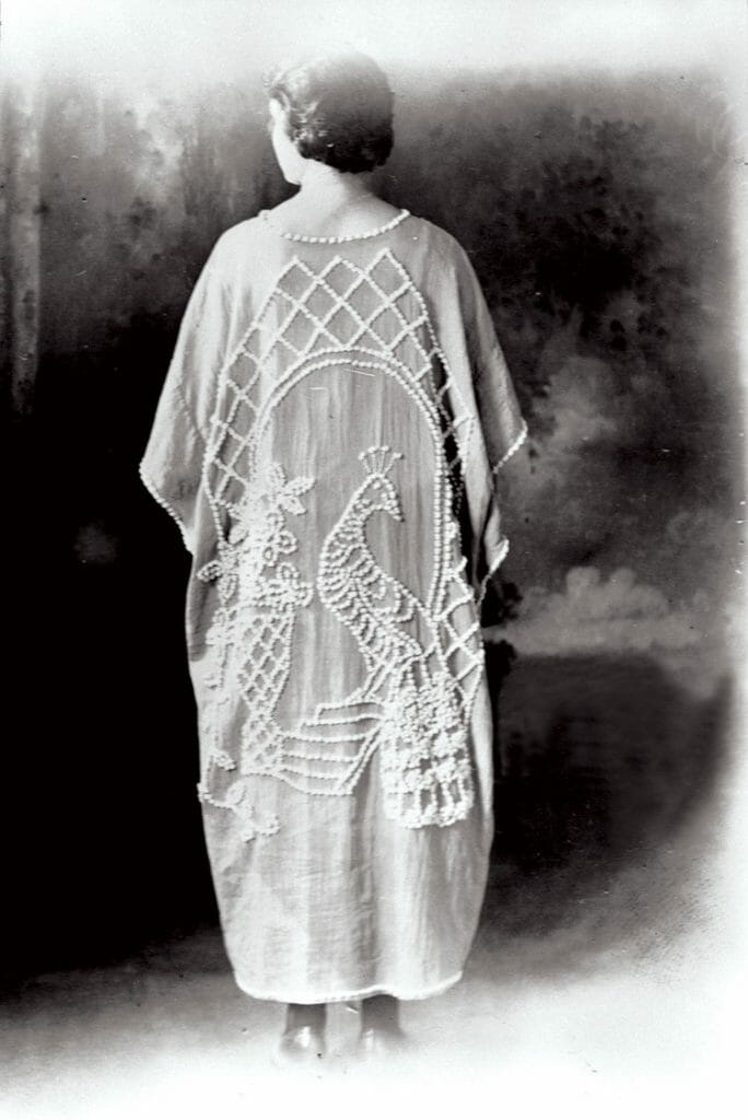 Mrs. Ralph Haney wearing a candlewick kimono with a peacock design, ca. 1920.