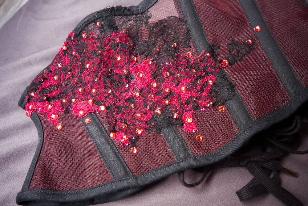 Closeup of lace appliqué front of Sparklewren sheer cincher.