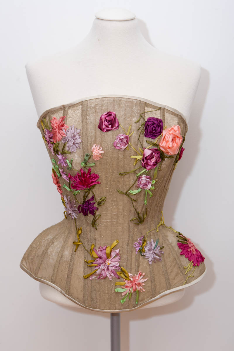 A bespoke corset in fine French lace and freehand silk ribbon embroidery. This corset shape had four fittings, and the final garment took several work days to stitch. Design by Karolina Laskowska