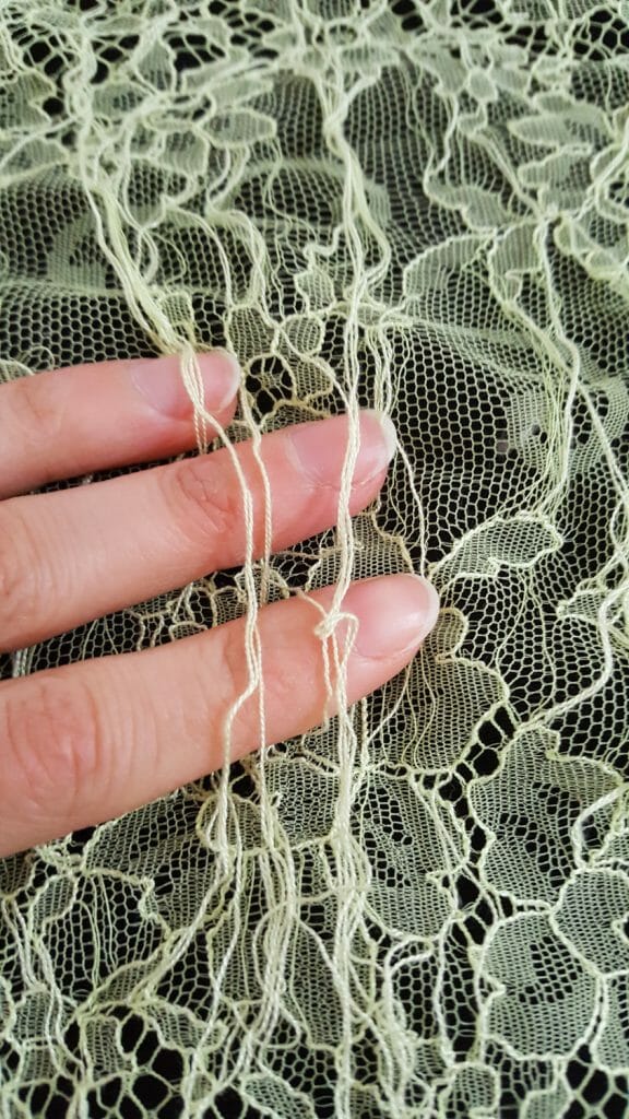A chantilly lace is characterised by an interrupted pattern through a tulle base. Each 'interruption' in the pattern causes the outline threads to 'skip', which then have to be trimmed off by hand. This is an incredibly time consuming process that requires skill and accuracy. Photo by Karolina Laskowska