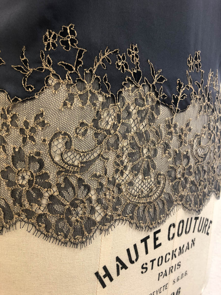 Detail of a lace appliquéd hem on a Merle Noir camisole. Image courtesy of Merle Noir