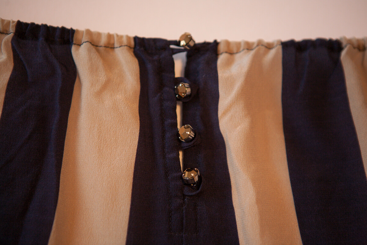 Crystal button detail on Rosamosario's silk palazzo pants. 