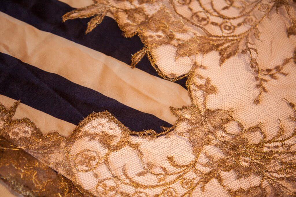 Lace appliqué detail on Rosamosario's silk palazzo pants. 