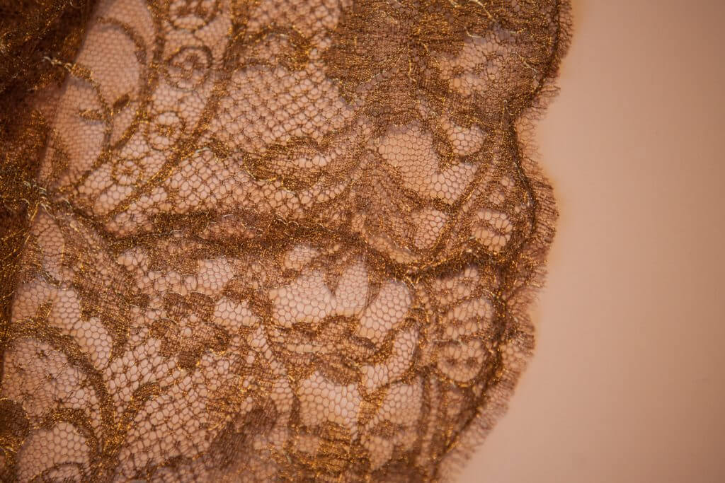 Lace seaming detail on Rosamosario's silk palazzo pants.