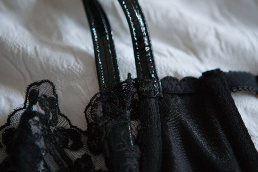 Exposed interior bra strap on the 'Oncilla' set by Loveday London. Leather lingerie.