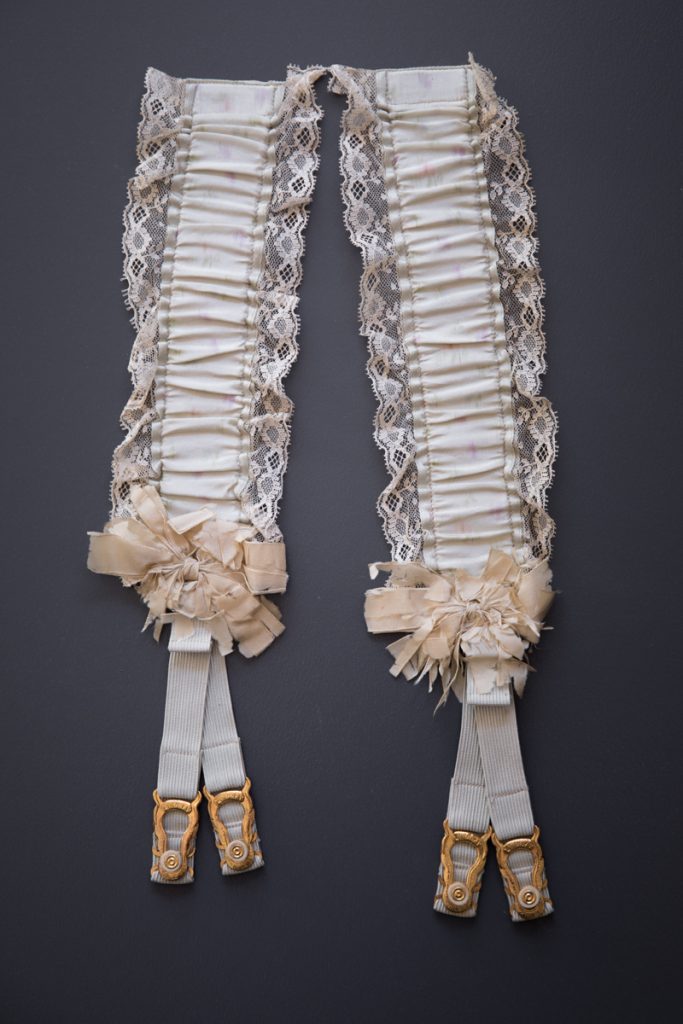 Silk hose supporters, c. 1890s, USA. These would have originally been pinned to a corset, with the straps reaching just above the knees. From The Underpinnings Museum collection. Photography by Tigz Rice