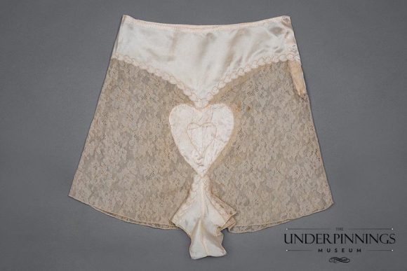 1930s satin and lace tap pants. This garment has been entirely sewn by hand, with impeccable finishing: tiny French seams, a rolled hem and exquisite embroidery. This single garment would have had hours of work poured into it. From The Underpinnings Museum Collection. Photo by Tigz Rice Studios