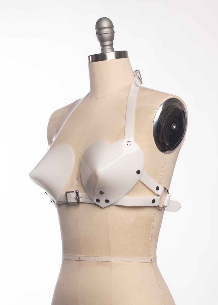 Apatico white, PVC bullet bra with heart shaped cups and buckle straps. On mannequin.