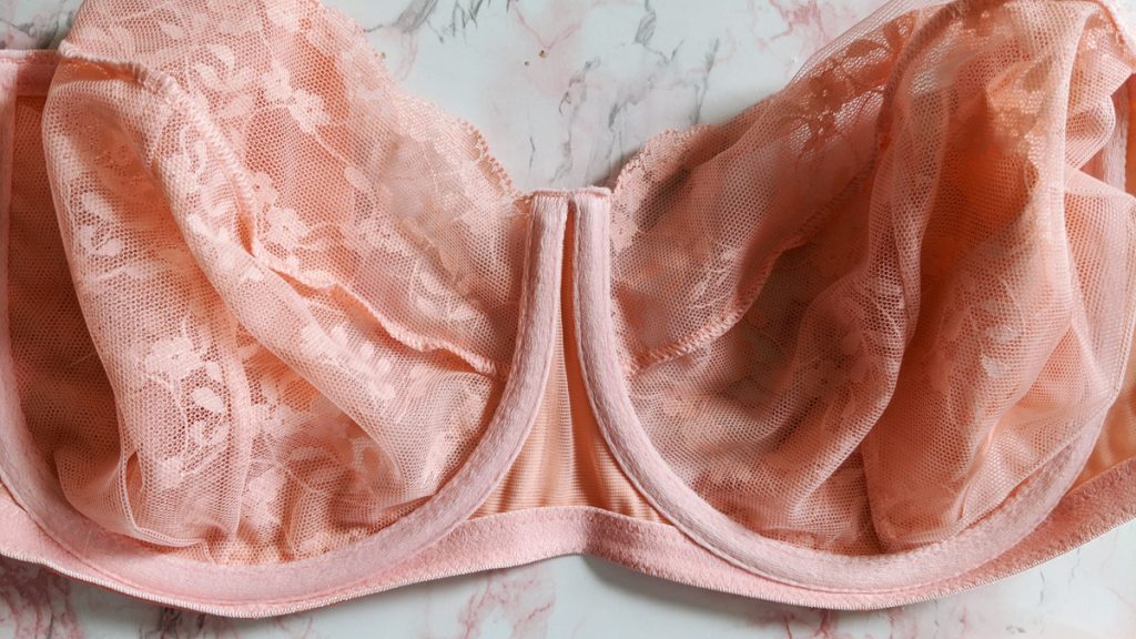 Close up of sheer, tulle, embroidery on Katherine Hamilton Sophia balconette bra. Horizontal seam across the front of bra cup visible.
