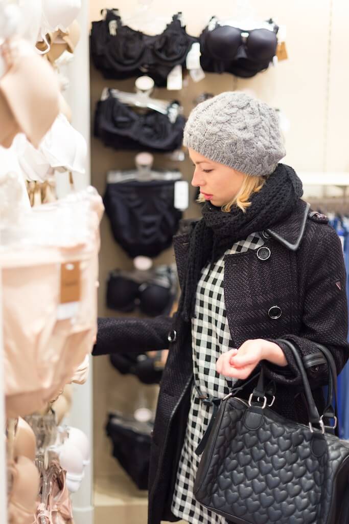 Image of shopper perusing bra selections.