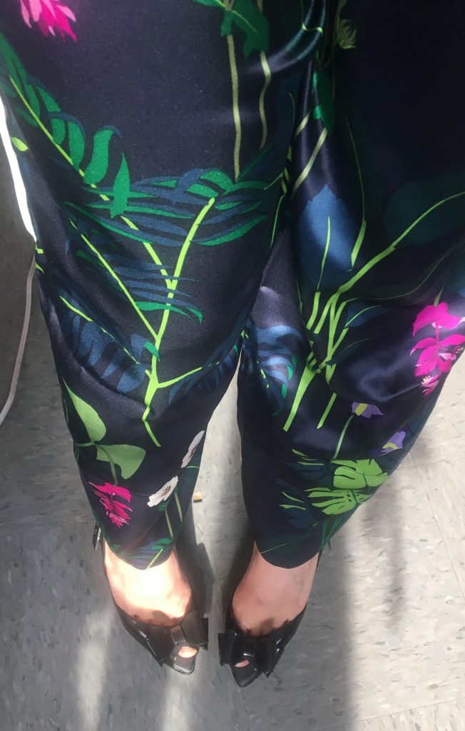 An example of silk lingerie you should not use our oil stain removal technique on. Photo is of a woman's legs from the midthigh down, wearing dark floral silk pajamas.