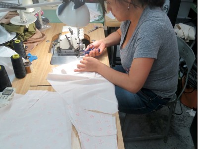 A silk slip being sewn in a New York City garment district factory