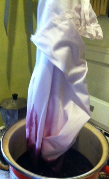 A slip being lowered into a dye bath to give it a nice ombre/bloodstained look.